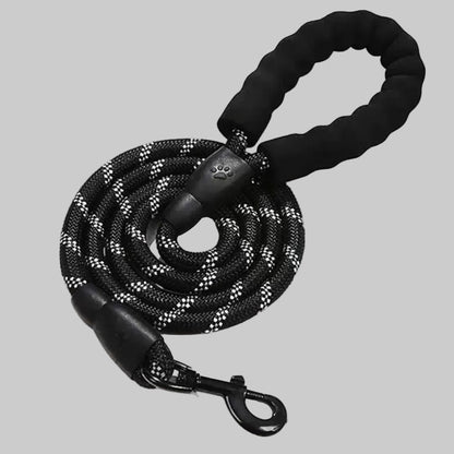 Black dog leash with paw print design on a gray background