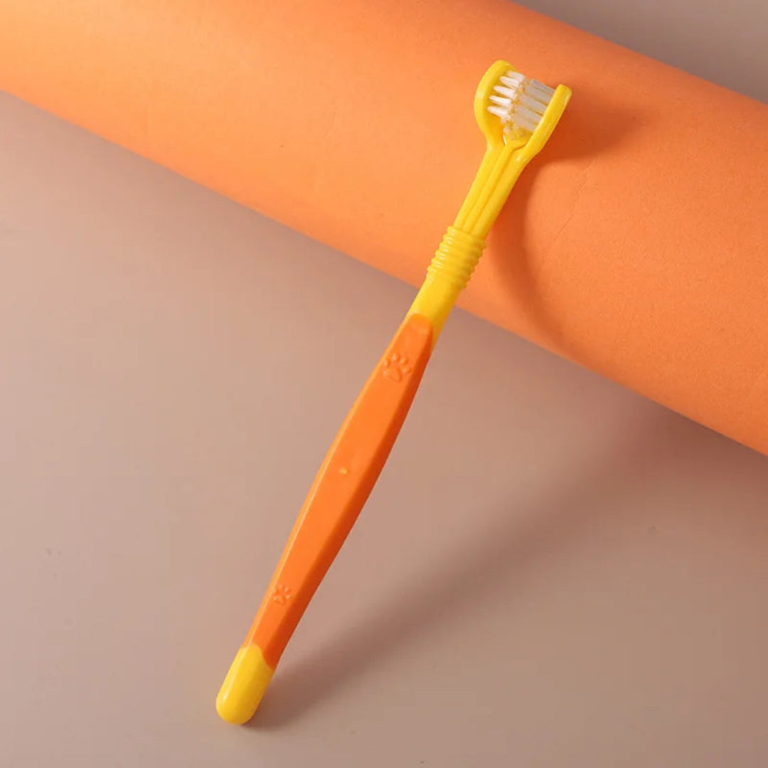 Yellow and orange toothbrush on a gradient background