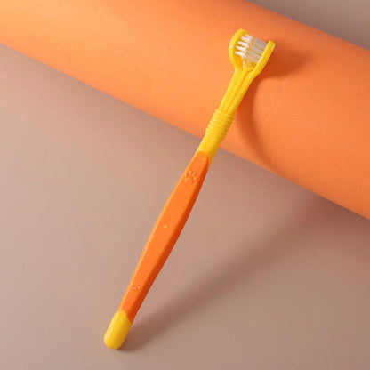 Yellow and orange toothbrush on a gradient background