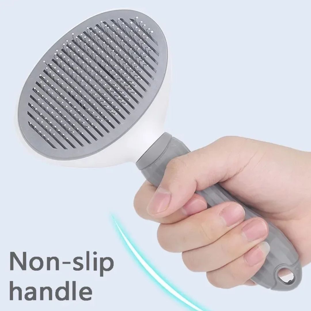 Gray handheld shower head with non-slip handle held by a hand on a light blue background