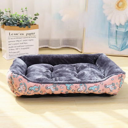 Dog pink bed with cartoon horse pattern on a wooden floor