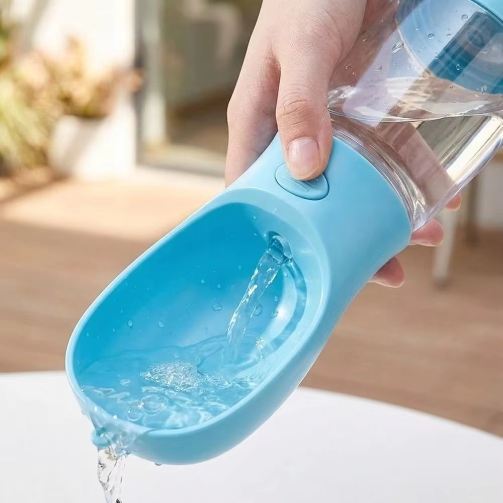 Blue pet water bottle being held with water flowing out, blurred background