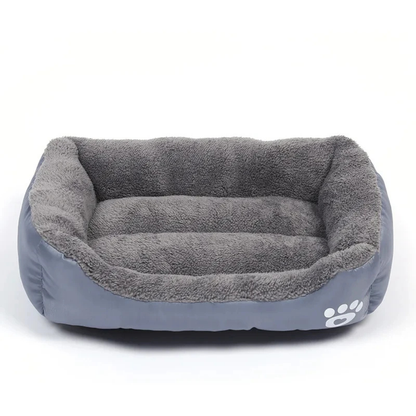 Gray pet bed with paw print design on a white background