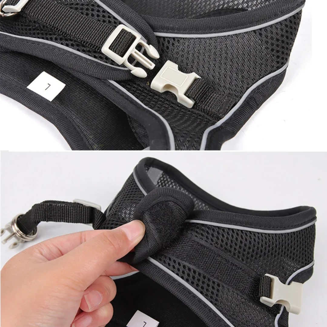 Black pet harness with adjustable straps on a white background