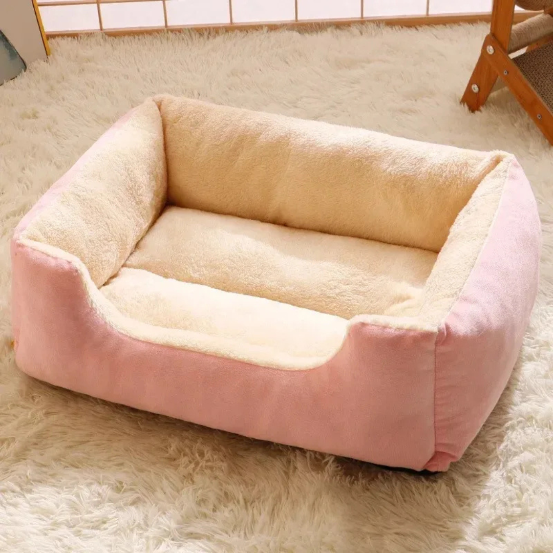 Pink and beige pet bed on a fluffy carpet